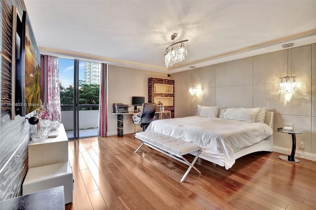 bedroom featuring an inviting chandelier and hardwood / wood-style flooring