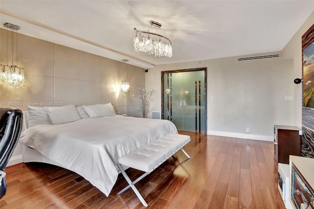 19667 Turnberry Way Unit 3E, Aventura, FL 33180 - bedroom featuring baseboards, a notable chandelier, and wood-type flooring