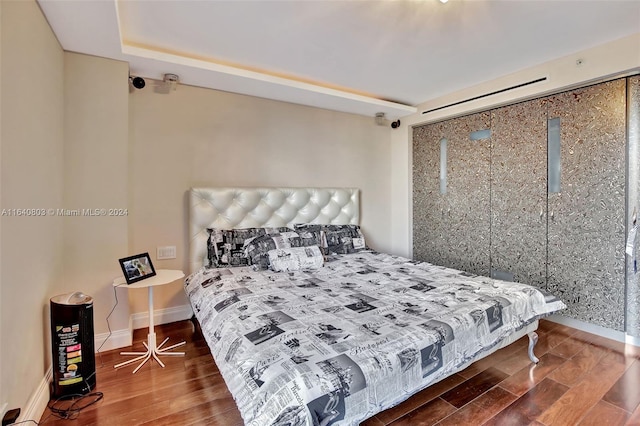 19667 Turnberry Way Unit 3E, Aventura, FL 33180 - bedroom with baseboards and wood finished floors