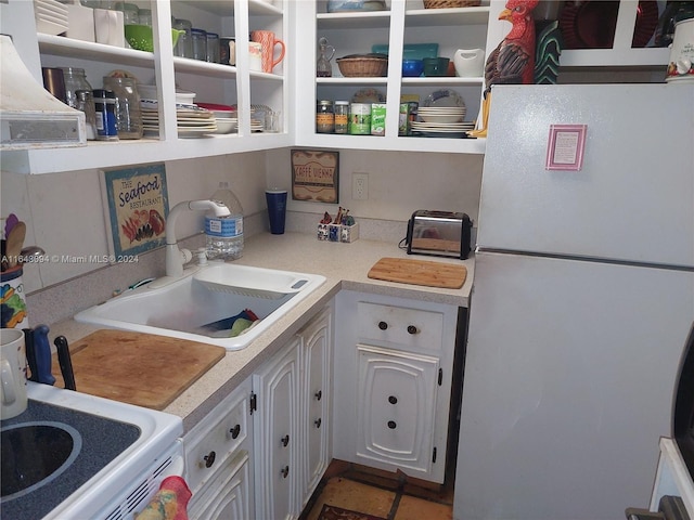 kitchen featuring white cabinetry, white appliances, and sink