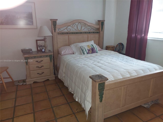 bedroom with dark tile patterned floors