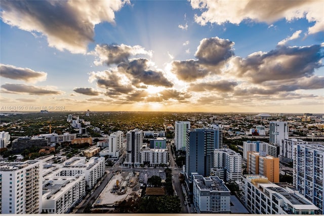 aerial view at dusk featuring a city view
