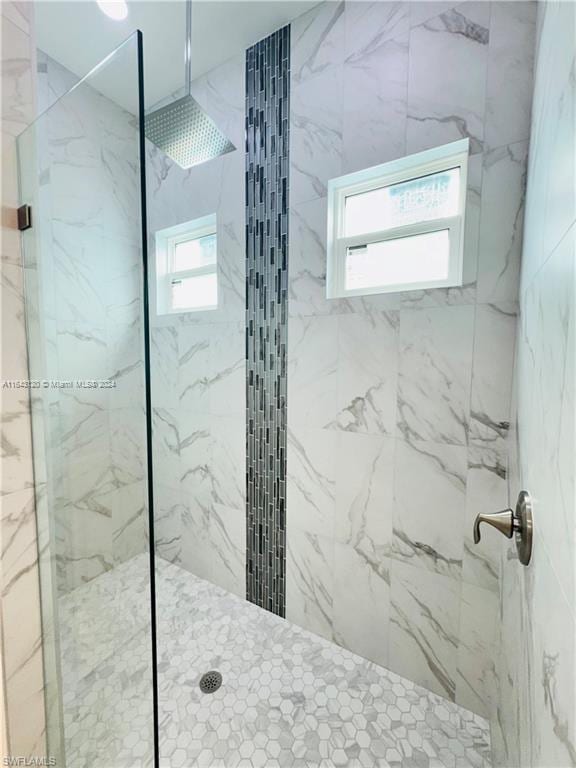 bathroom with tiled shower