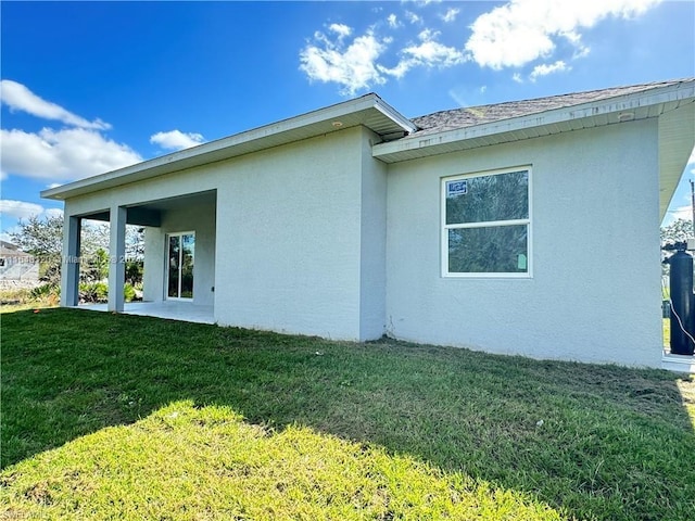 view of property exterior with a yard