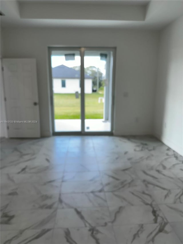 spare room with a tray ceiling