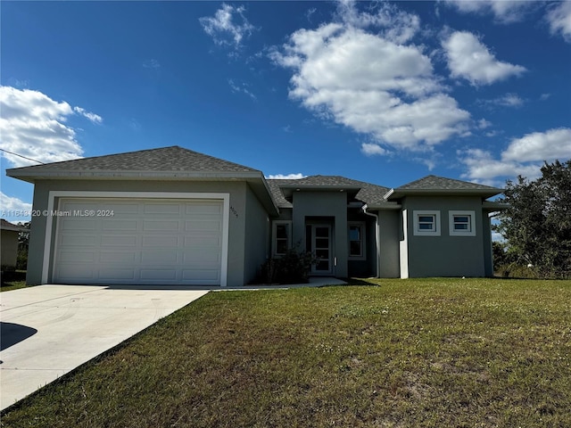 view of front of property with a front lawn and a garage