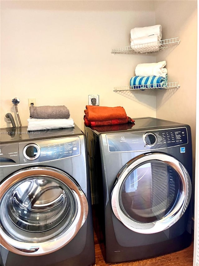 clothes washing area with washer and clothes dryer