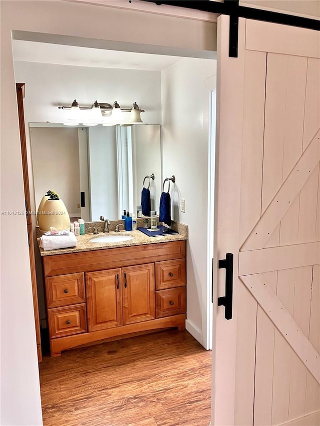 bathroom featuring vanity and hardwood / wood-style floors