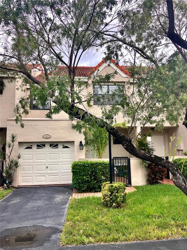 view of front of property featuring a front yard and a garage