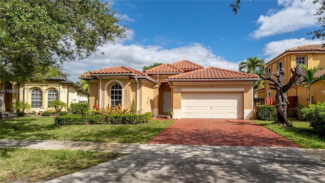 mediterranean / spanish home with a front lawn and a garage