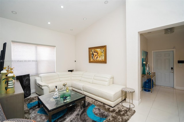 tiled living room featuring vaulted ceiling