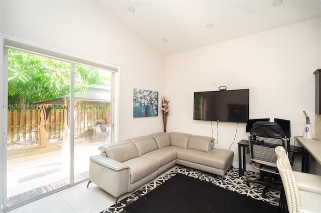 tiled living room featuring vaulted ceiling