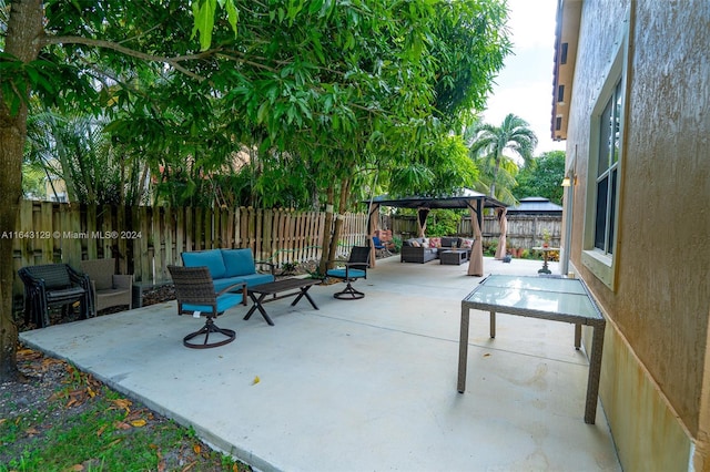 view of patio with outdoor lounge area and a gazebo