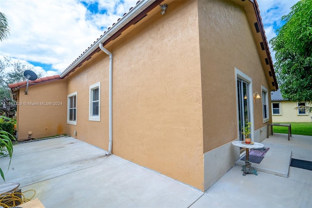 view of property exterior with a patio