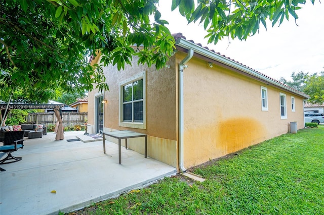 view of home's exterior featuring a lawn and a patio area