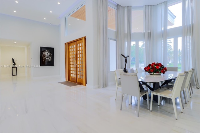 dining room with french doors, a high ceiling, and recessed lighting