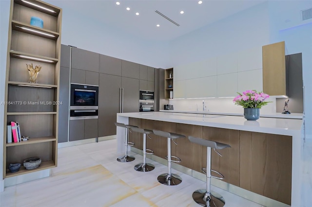 kitchen with open shelves, light countertops, white cabinets, modern cabinets, and a kitchen breakfast bar