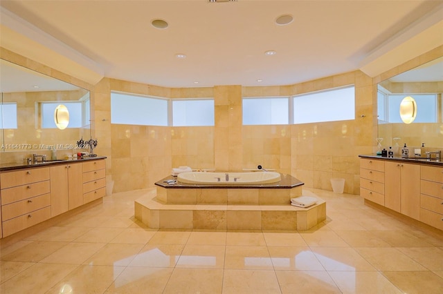 full bath with tile patterned flooring, a sink, tile walls, and a bath