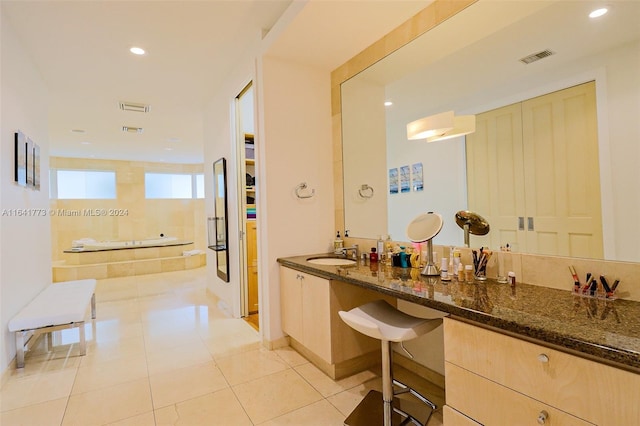 hall with recessed lighting, light tile patterned flooring, a sink, and visible vents