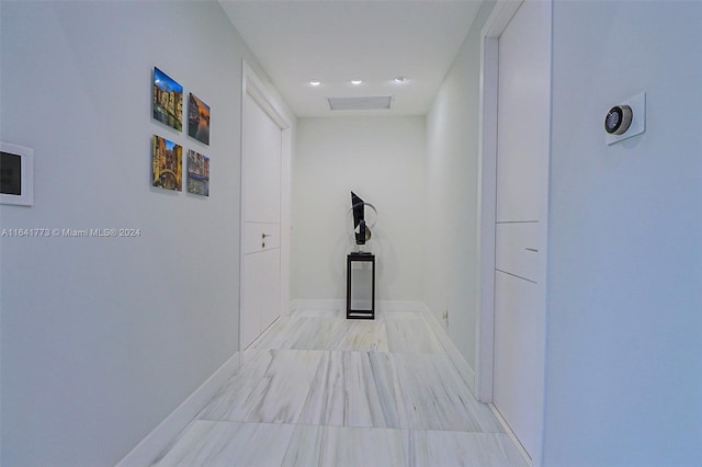 hallway featuring visible vents and baseboards