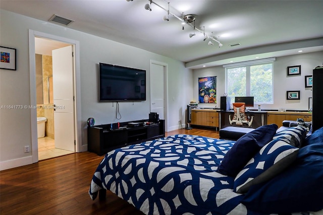 bedroom featuring rail lighting, wood finished floors, visible vents, and recessed lighting