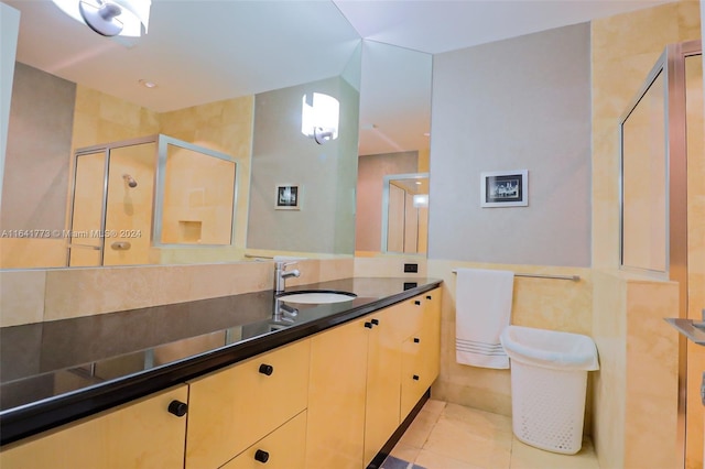 full bathroom featuring vanity, a shower stall, and tile patterned floors