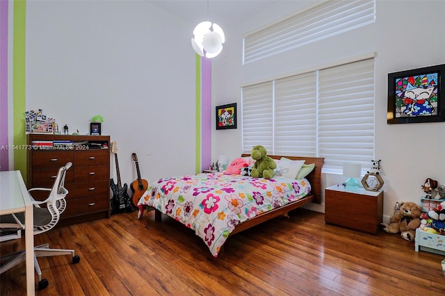 bedroom with dark wood-style floors