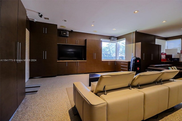 home theater with light speckled floor and recessed lighting