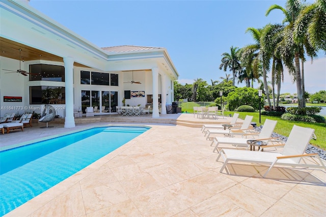 outdoor pool with a patio area and ceiling fan