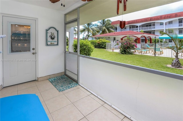 doorway to outside featuring tile patterned flooring and ceiling fan