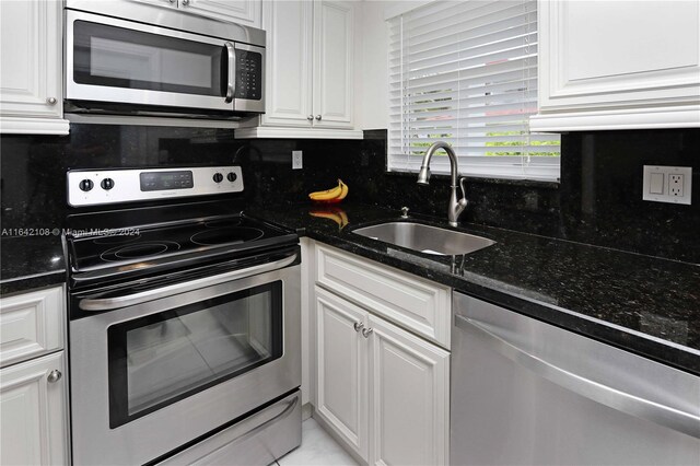 kitchen with sink, white cabinetry, and appliances with stainless steel finishes