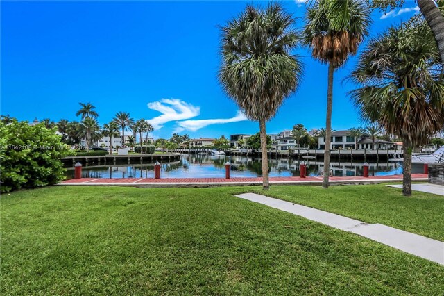 dock area featuring a yard and a water view