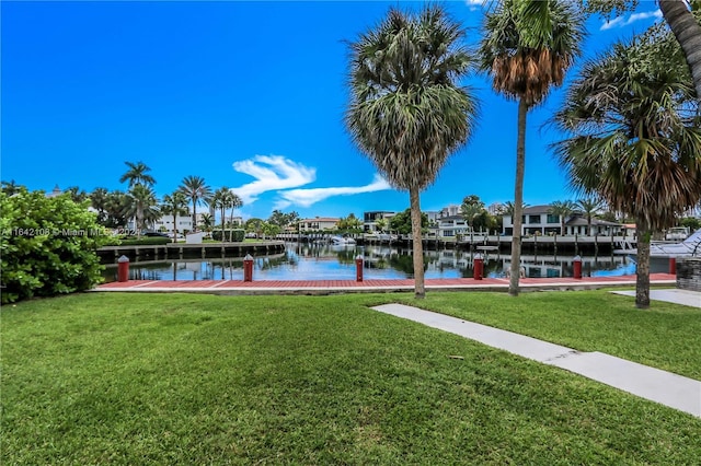 dock area with a water view and a yard