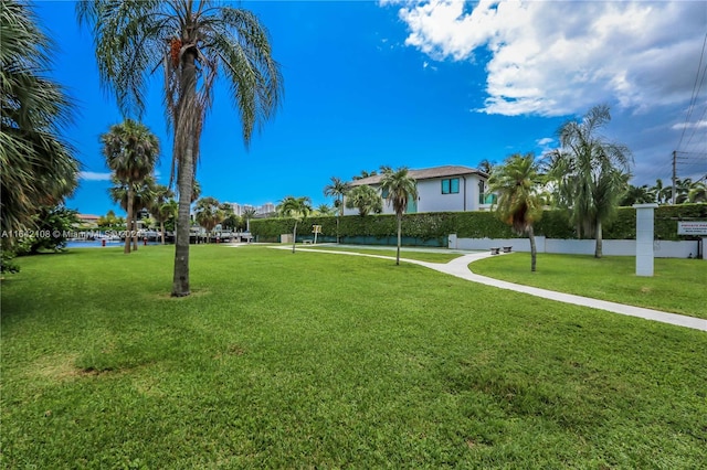 view of community with a water view and a lawn