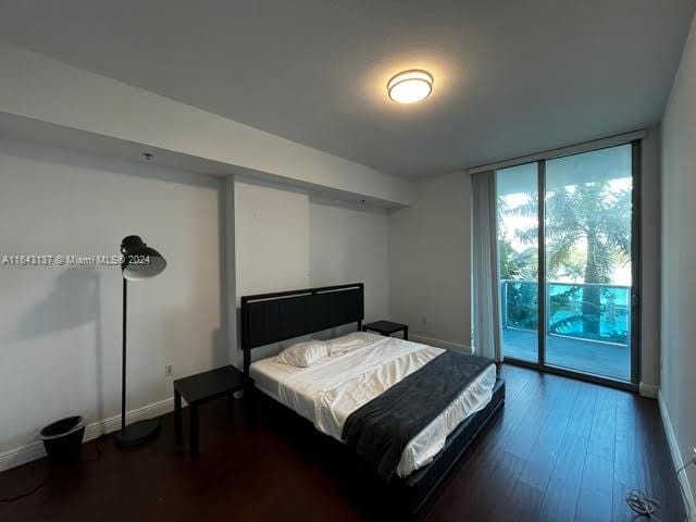 bedroom featuring hardwood / wood-style flooring and access to outside