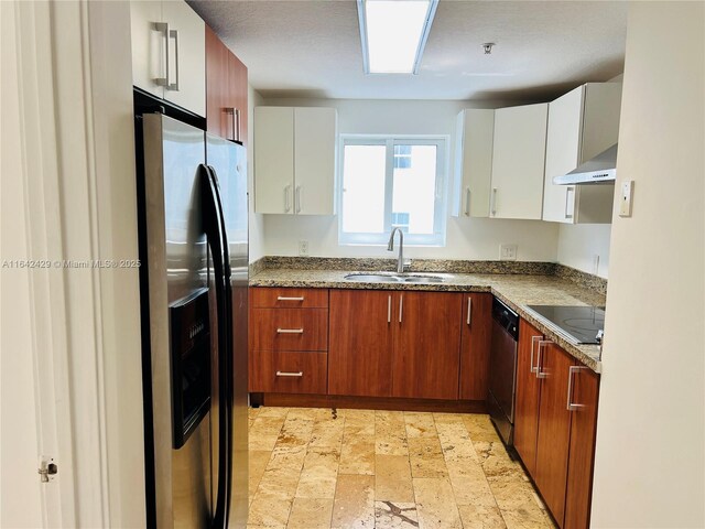 kitchen featuring wall chimney exhaust hood, sink, white cabinets, and appliances with stainless steel finishes