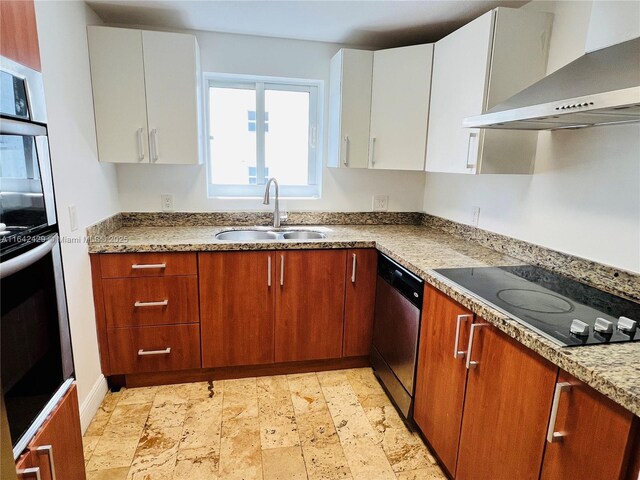 kitchen featuring sink, wall chimney range hood, stainless steel dishwasher, black electric cooktop, and white cabinets