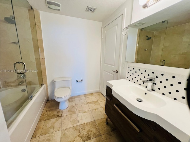 full bathroom with vanity, toilet, and shower / bath combination with glass door