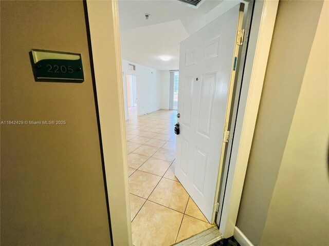 hall with light tile patterned flooring