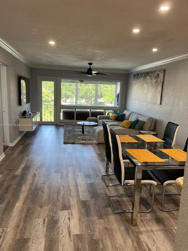 dining room with ceiling fan, crown molding, and hardwood / wood-style floors