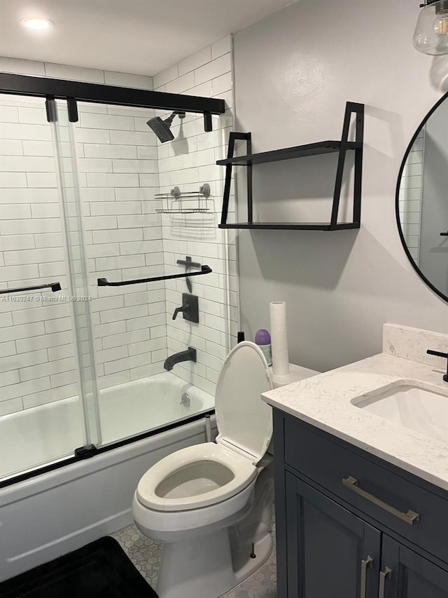 full bathroom featuring bath / shower combo with glass door, vanity, and toilet