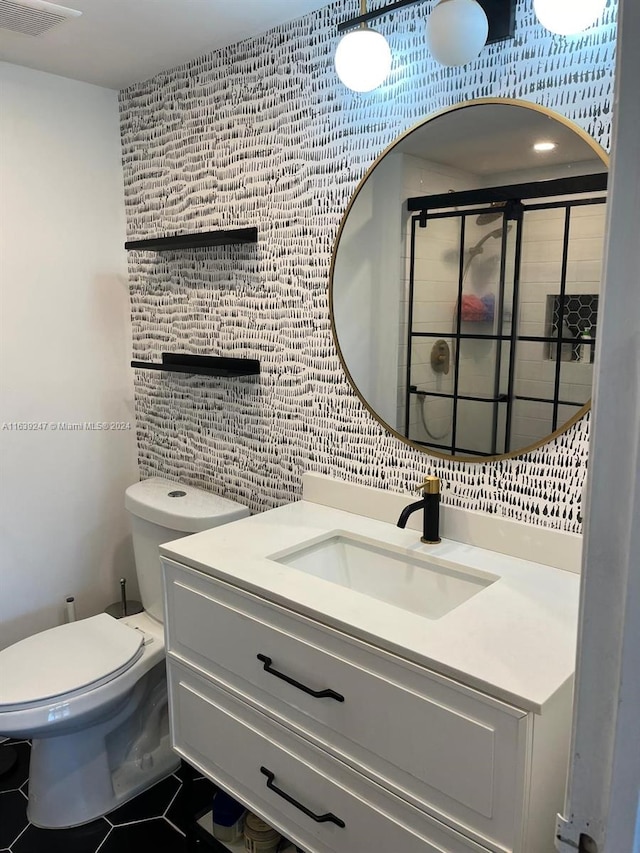 bathroom with toilet, tasteful backsplash, tile walls, vanity, and tile patterned flooring