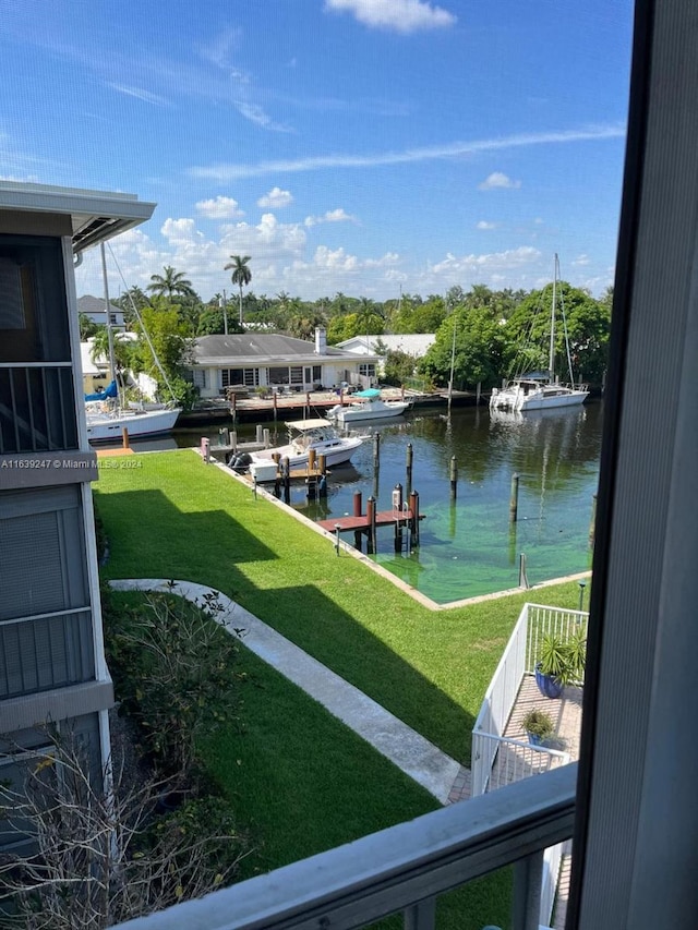 exterior space with a water view and a lawn