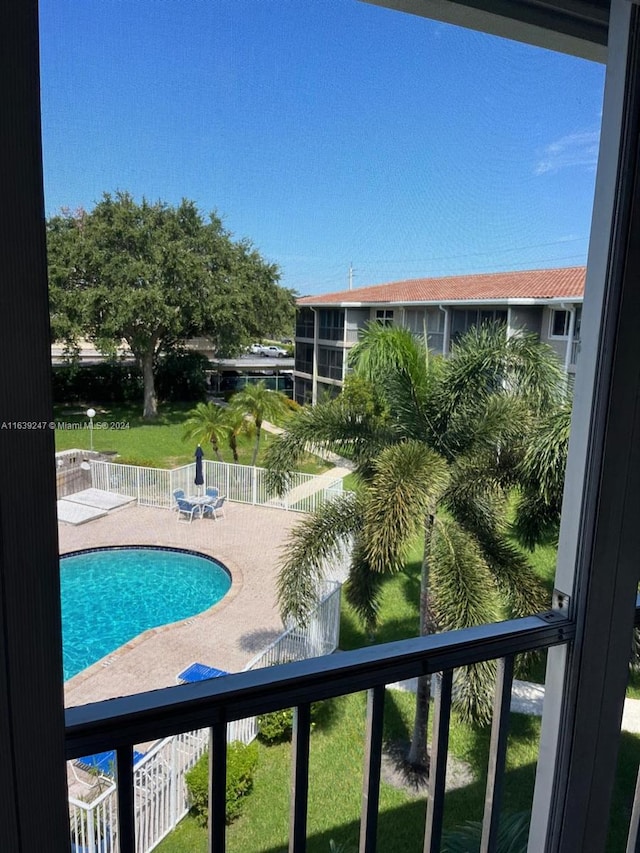 view of pool featuring a patio and a lawn