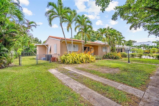 view of front of house featuring a front lawn and central air condition unit