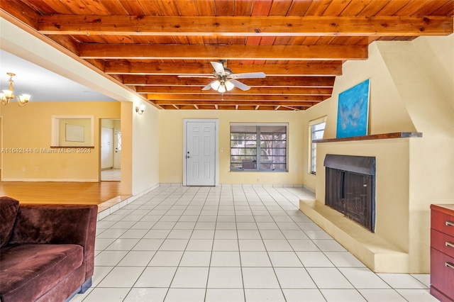 tiled living room with beam ceiling, ceiling fan with notable chandelier, and wooden ceiling