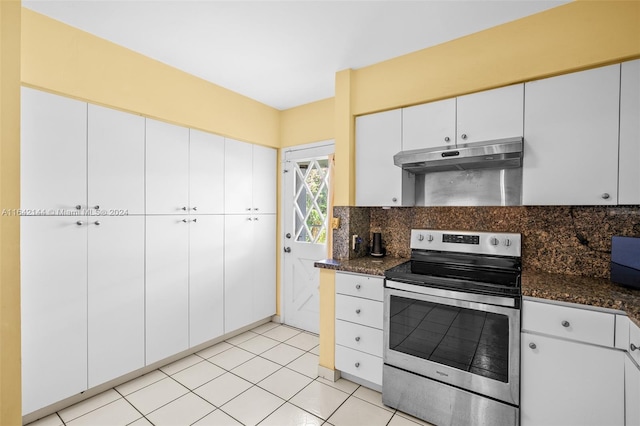 kitchen featuring stainless steel range with electric stovetop, white cabinetry, backsplash, and dark stone counters