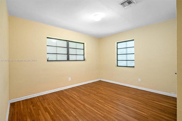 spare room with hardwood / wood-style floors