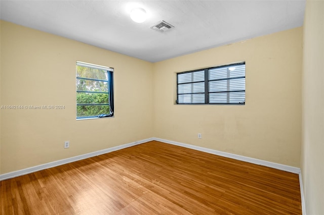 empty room with hardwood / wood-style flooring