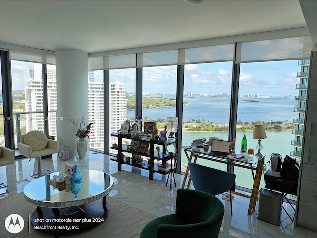 living room featuring floor to ceiling windows and a water view